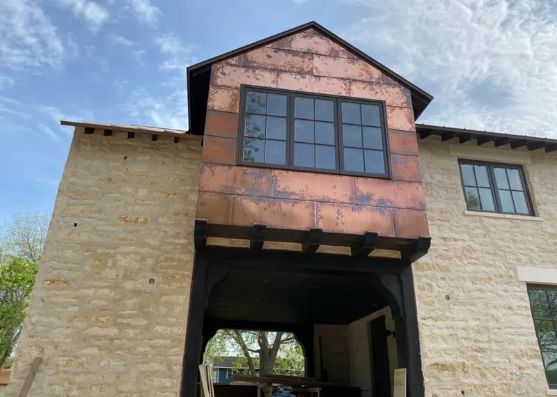 Copper metal panel facade on a stone building for Roof Repair in Titusville
